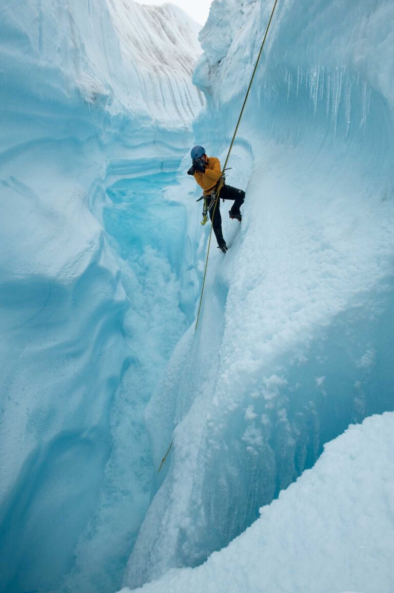 Extreme Ice Survey Founder and Director James Balog rappels into Survey Canyon, looking down a moulin channel dropping meltwater 2000 vertical feet into crevasses through Greenland Ice Sheet, Survey Canyon, Greenland (2009)